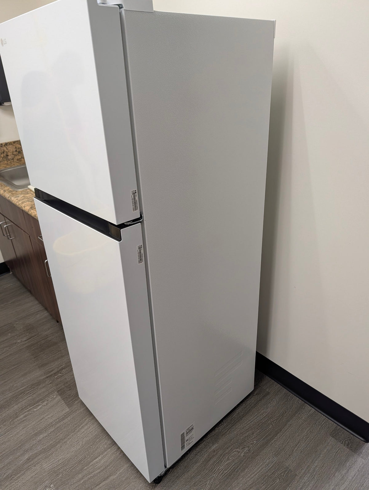 LG white top-freezer refrigerator, side view