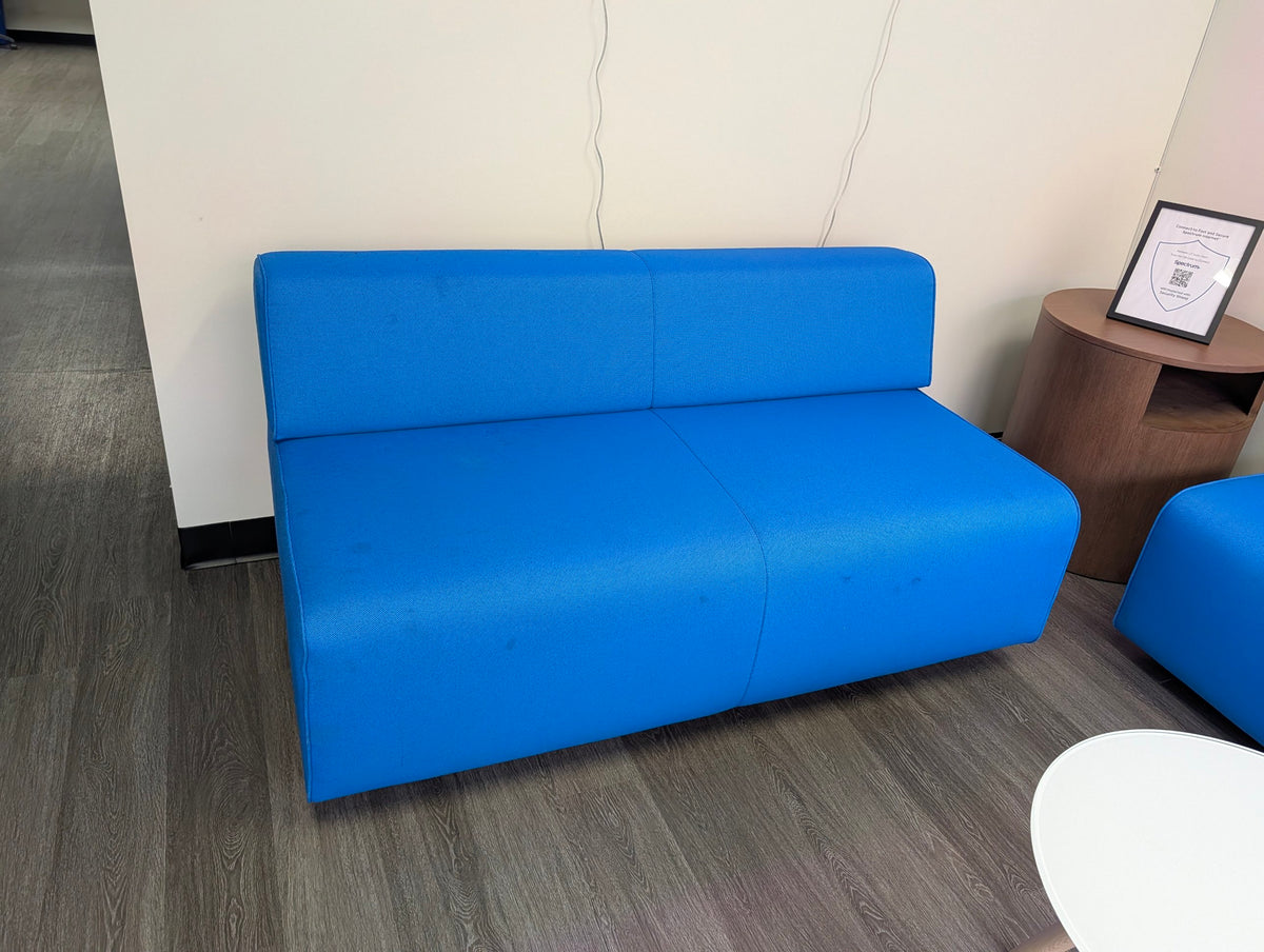 Blue armless lounge loveseat with light marks on seat