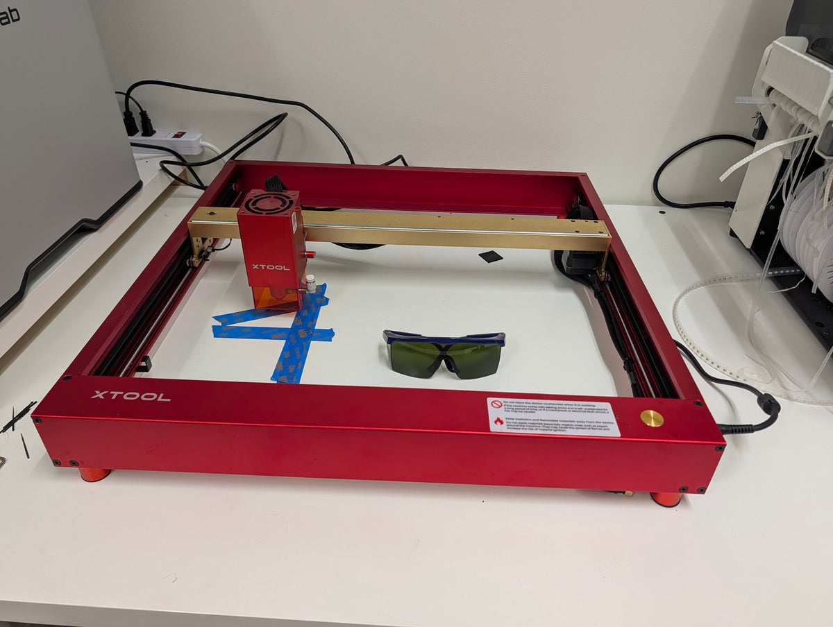 Used xTool D1 Pro 10W laser engraver, golden red frame, with laser safety goggles